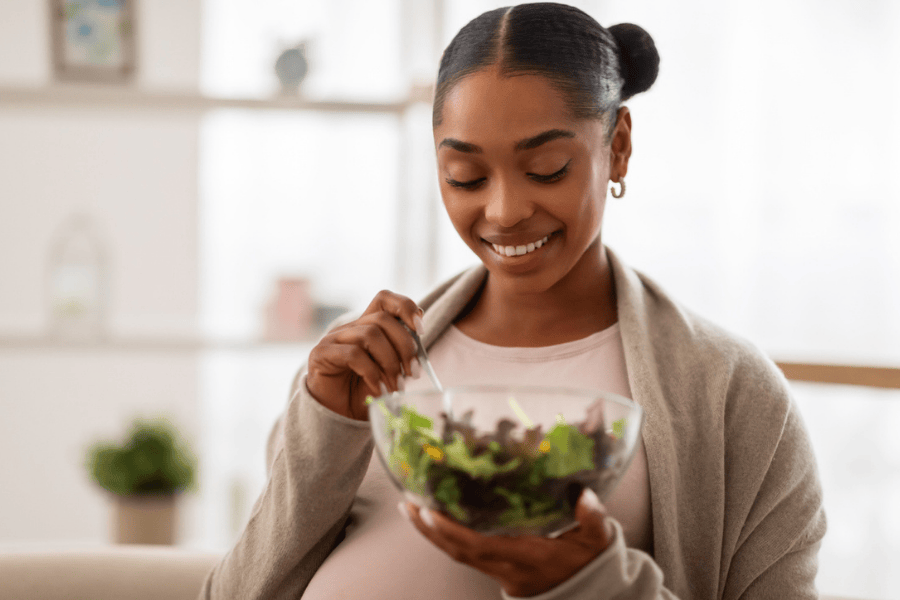 Young Pregnant Woman Eating a Healthy Salad