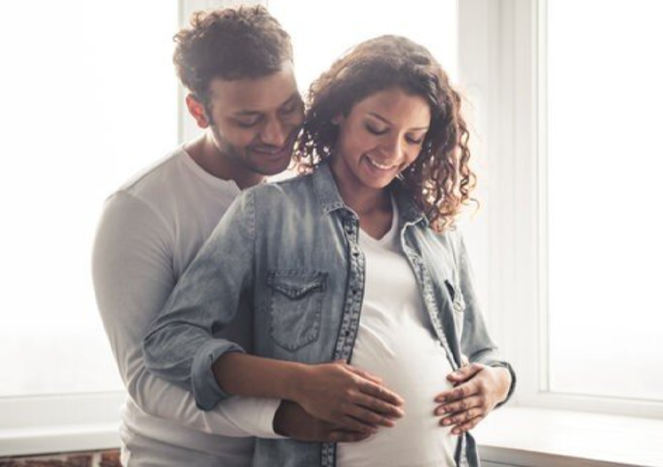 Parents looking at baby bump