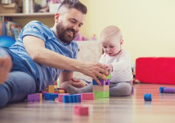 Dad playing with baby